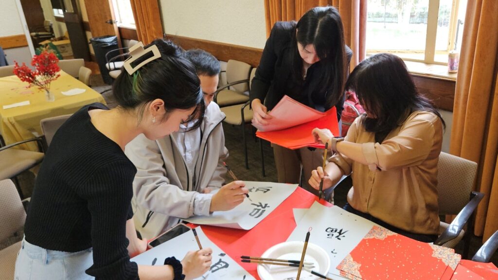 Group of people writing in chinese caligraphy