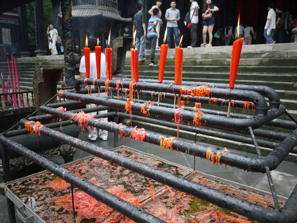 Candles melting on a metal bar