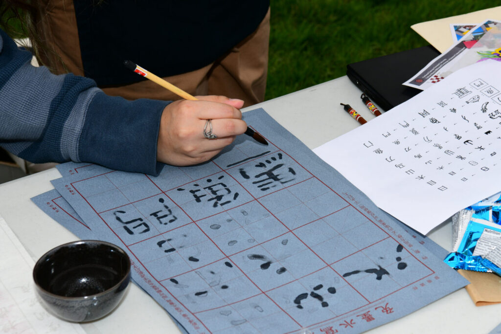Person writing chinese calligraphy